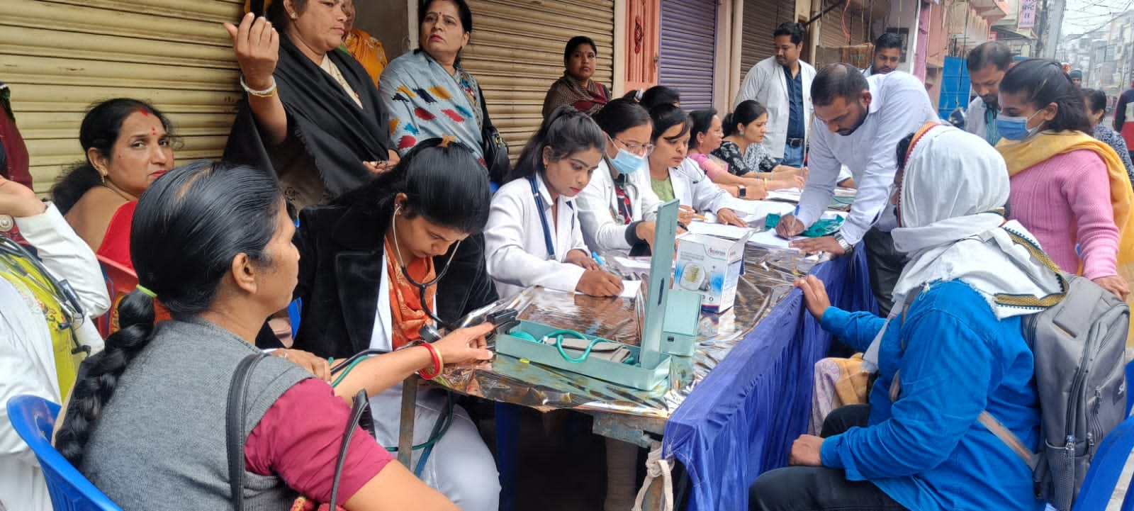 Check up of patients being done by students from Mahatma Gandhi Homoeopathic Medical College in a medical camp.