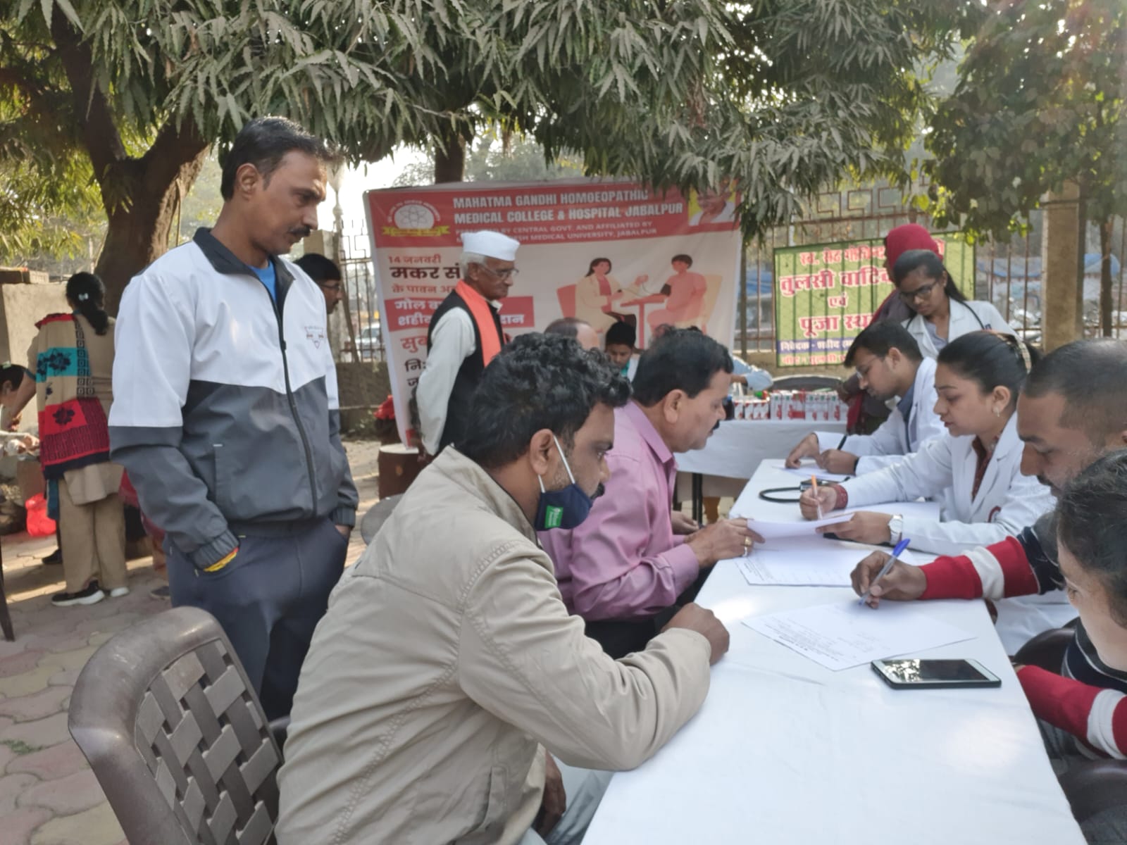 Check up of patients being done by students from Mahatma Gandhi Homoeopathic Medical College in a medical camp.