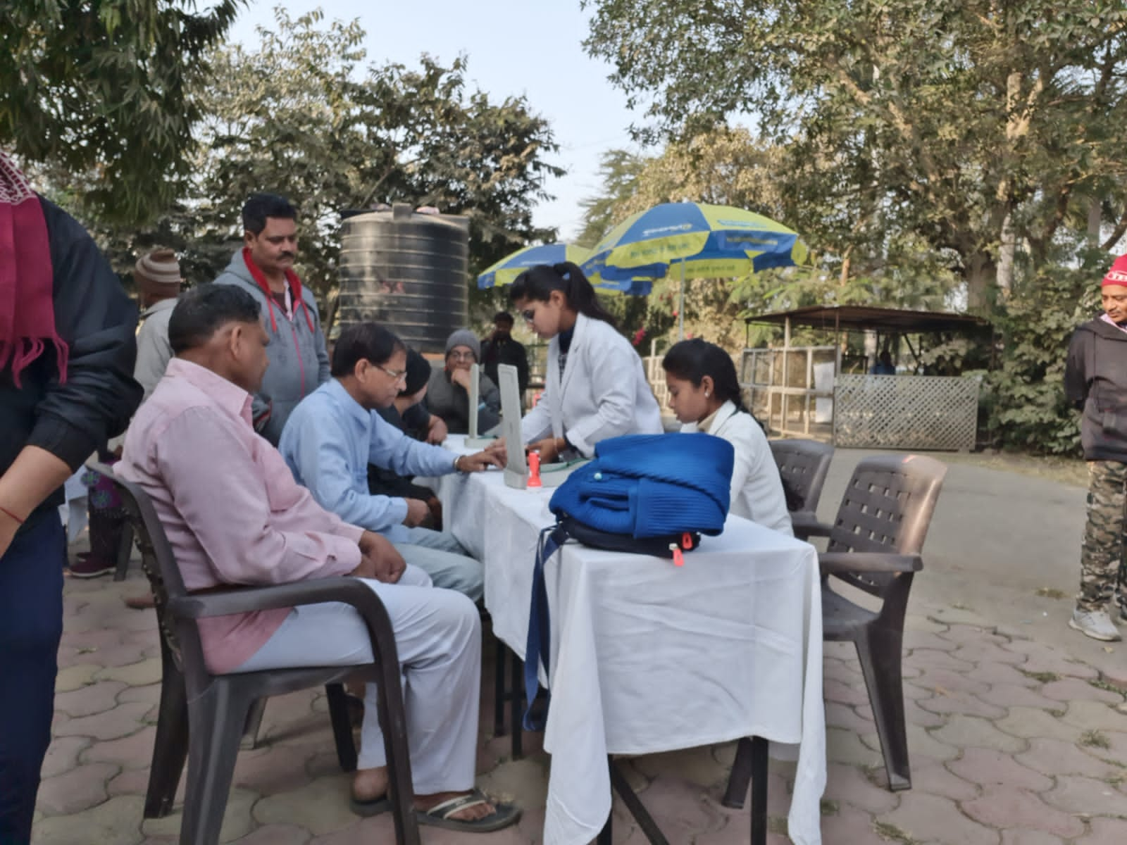 Check up of patients being done by students from Mahatma Gandhi Homoeopathic Medical College in a medical camp.