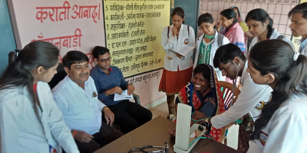 Check up of patients being done by students from Mahatma Gandhi Homoeopathic Medical College in a medical camp.